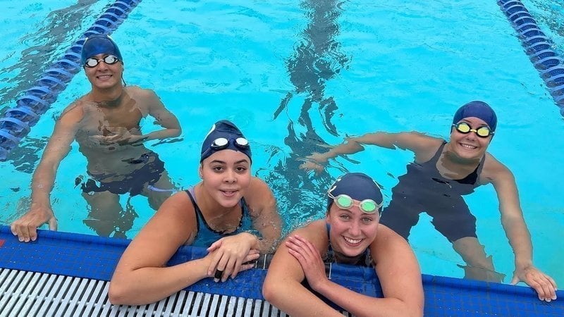 Four swimmers on the wall.